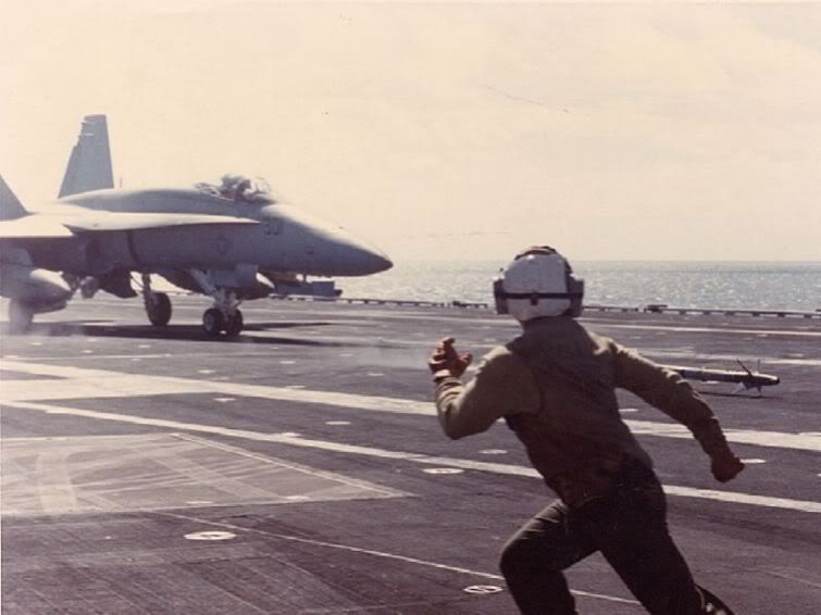 crewman-runs-for-cover-as-fighter-p.jpg
